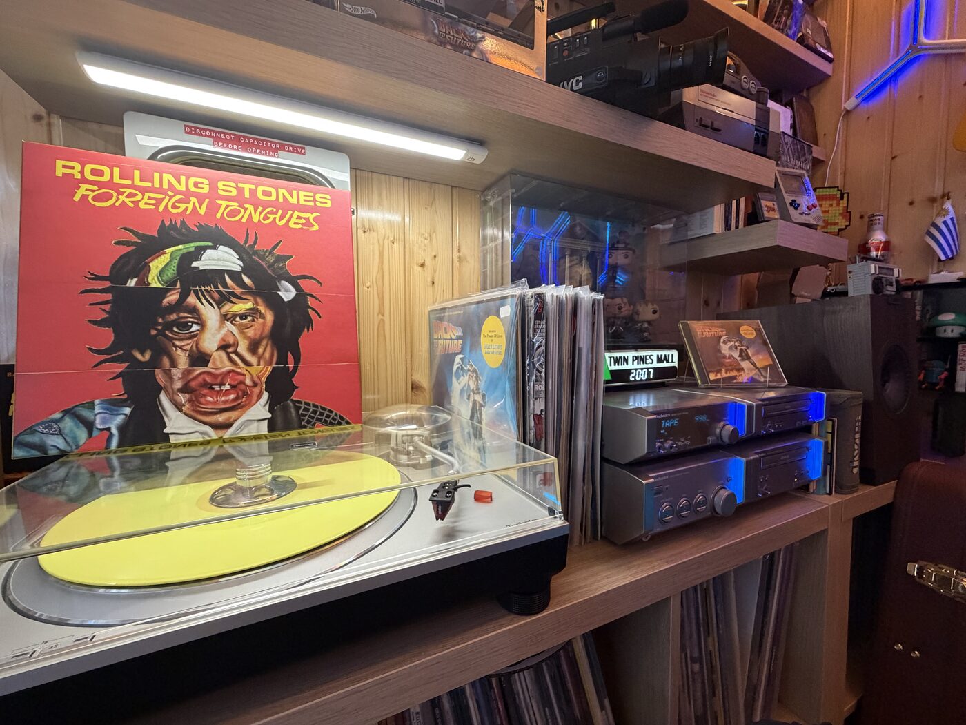 A yellow vinyl pressing spinning on the turntable